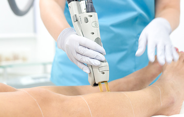 A Laser Technician is Processing Laser Hair Removal Treatment on a Patient’s Half Legs